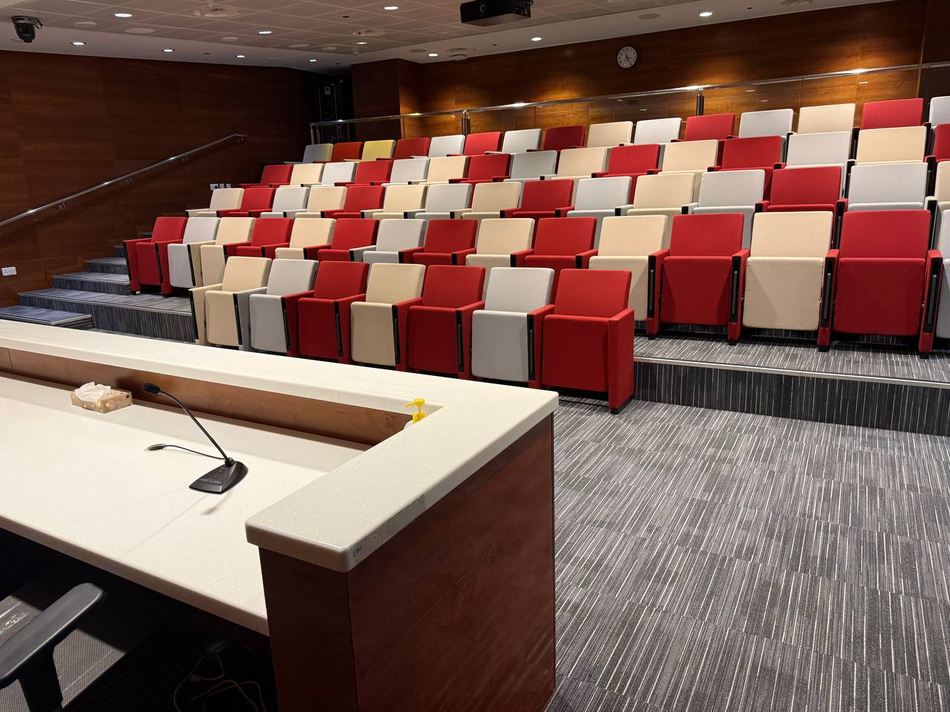 The speaker position at the front of the conference room, with stepped rows rising behind