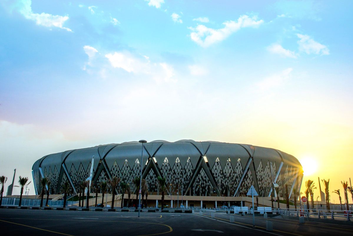 The diamond façade of Alinma Stadium at sunset, patterned after Jeddah's rawshan screens