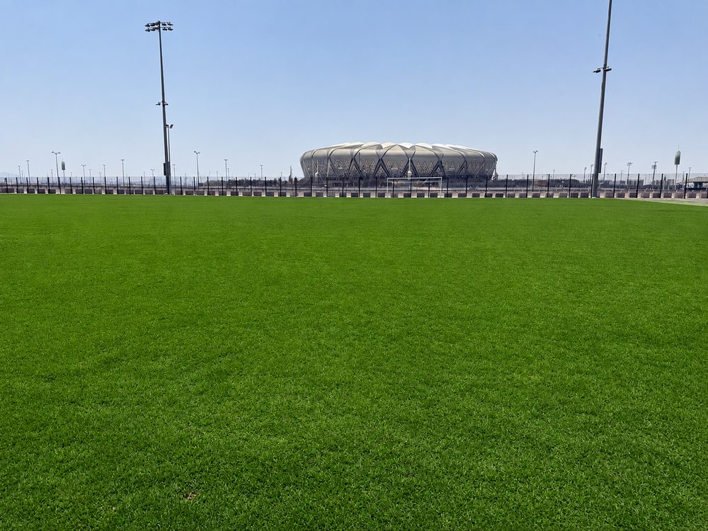 A full-size grass pitch inside the secured perimeter