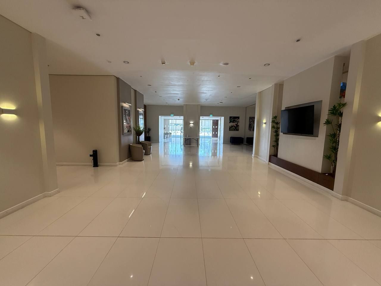 The long corridor running to the glazed doors