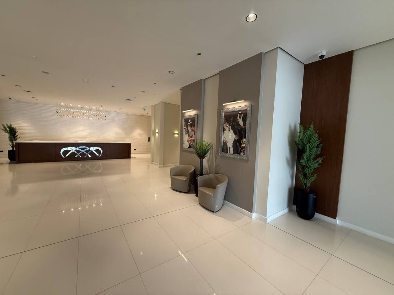 The reception hall lined with portraits and lounge chairs