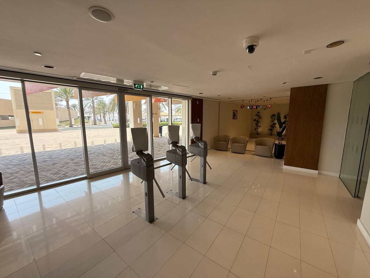 Screening turnstiles inside the glazed gold and silver entrance