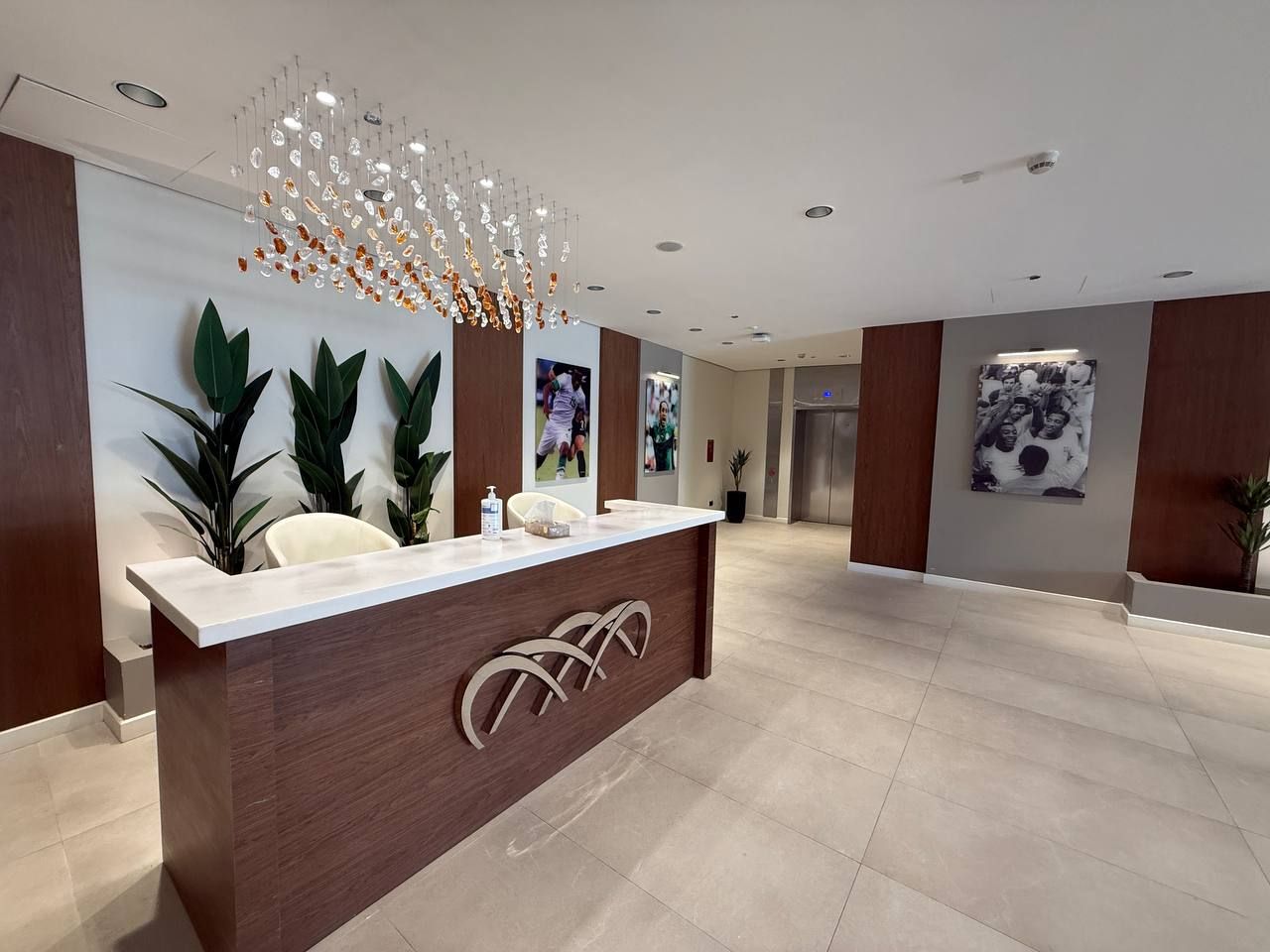 The VIP reception desk beneath the crystal chandelier
