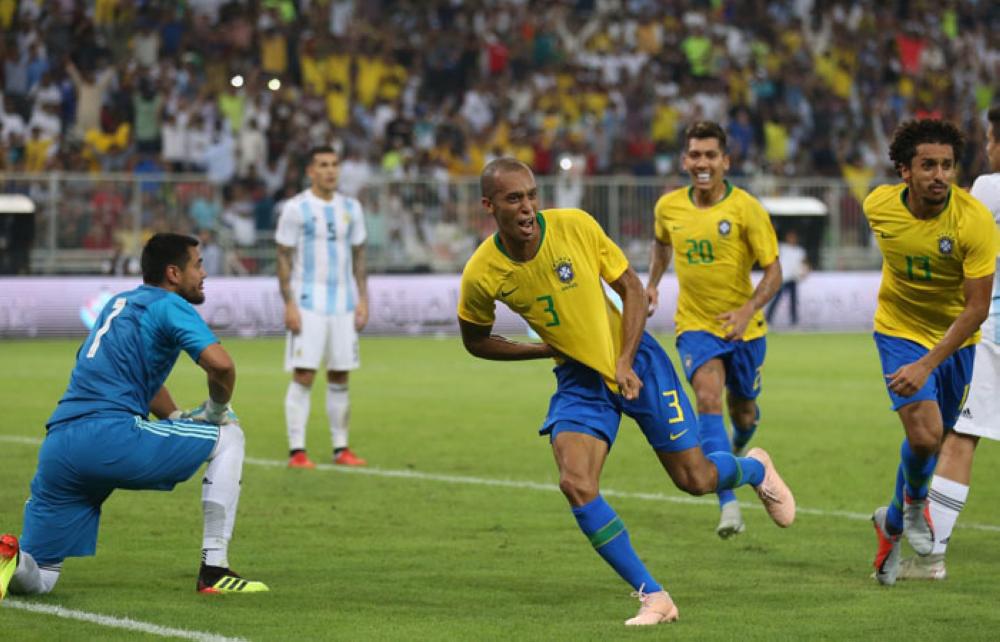Miranda wheels away in celebration after heading Brazil in front, with the Argentina goalkeeper on his knees
