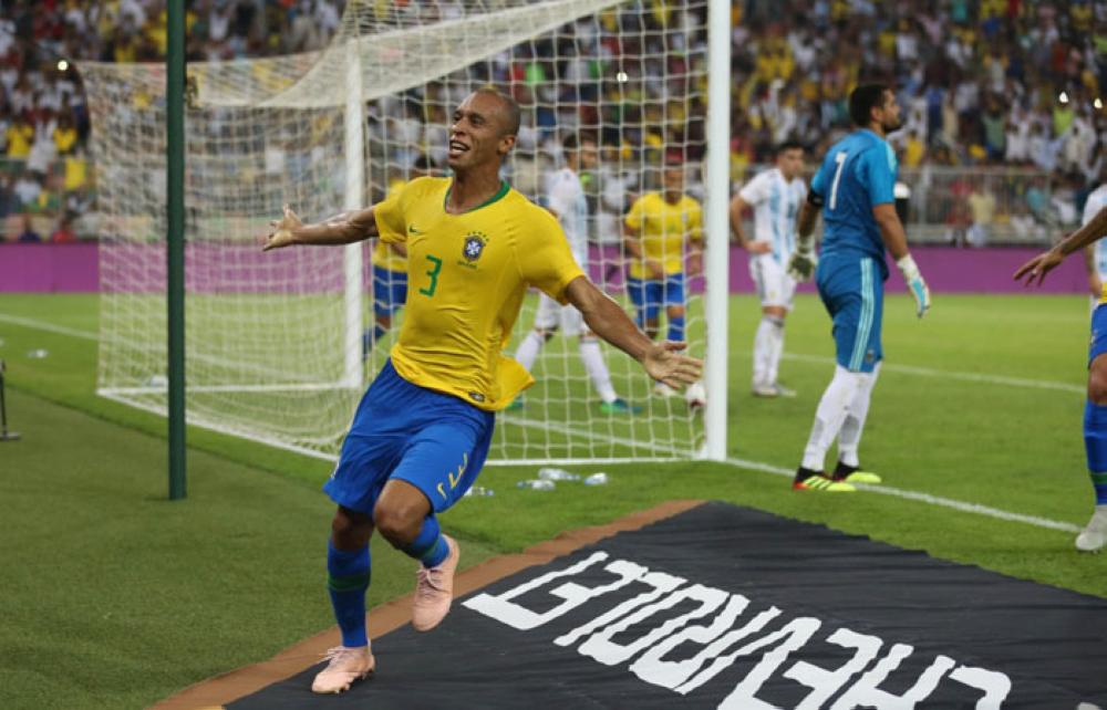 Miranda runs behind the goal with arms outstretched after scoring